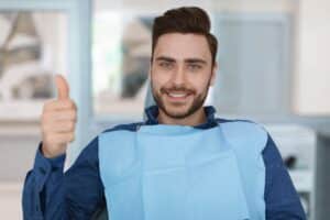 Cheerful,Bearded,Man,Patient,Sitting,In,Dental,Chair,And,Smiling