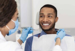 A man sitting in a dentist's chair discussing a sinus lift in Houston, TX